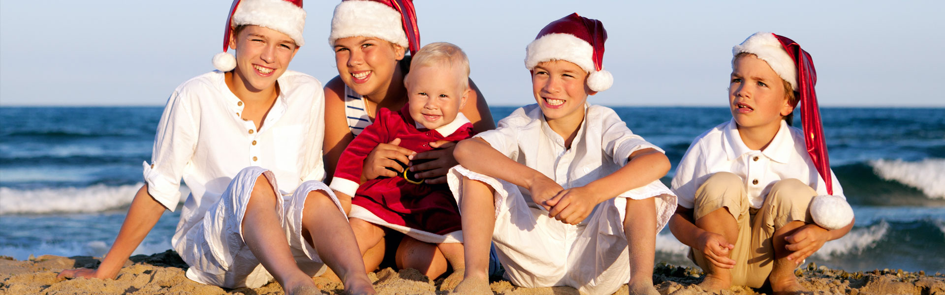 Children Sitting on the Beach with Santa Hats Winter Wonder Island, Galveston, TX
