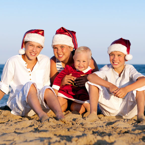 Children Sitting on the Beach with Santa Hats Winter Wonder Island, Galveston, TX