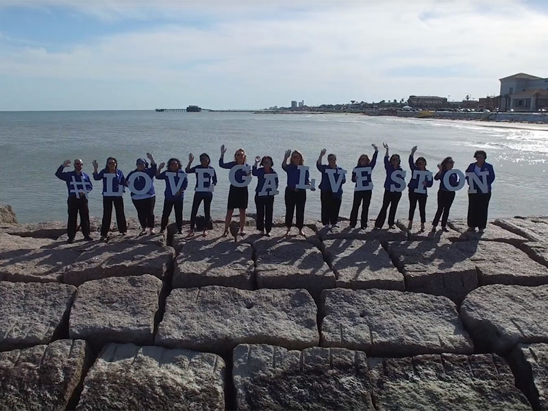 CVB Staff on Jetty with Love Galveston Signs