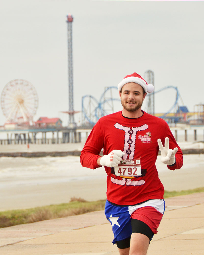 Guy Running in Santa Hustle Race