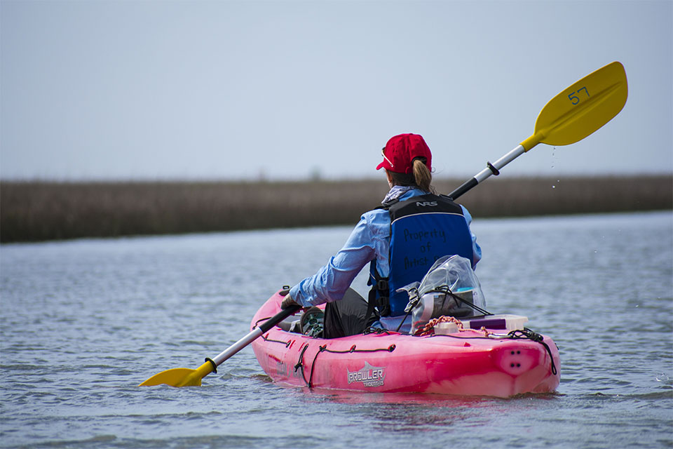 Woman Kayaking in East End Lagoon Woman Kayaking in East End Lagoon