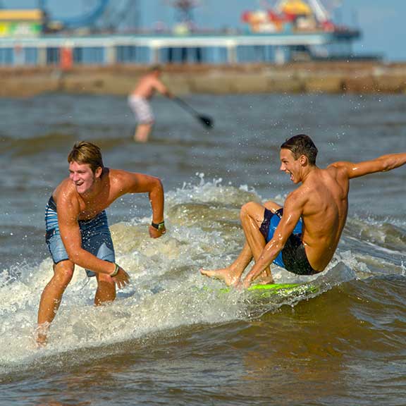 Boys Surfing at the Beach