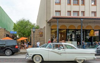 Couple Driving Classic Auto Down The Strand