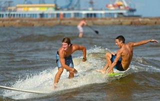 Surfers Near the Pleasure Pier