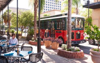 A Trolley Passes a Postoffice Street Eatery