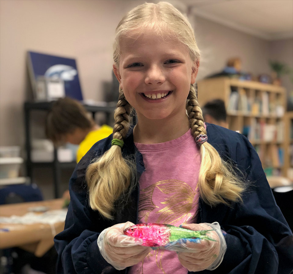 Girl at Camp Holding a Painted Fish Girl at Camp Holding a Painted Fish