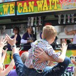 Kid on Shoulders Catching Beads