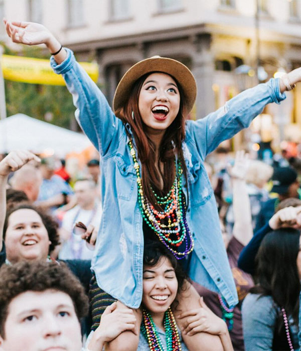 Woman on Shoulders Catching Beads